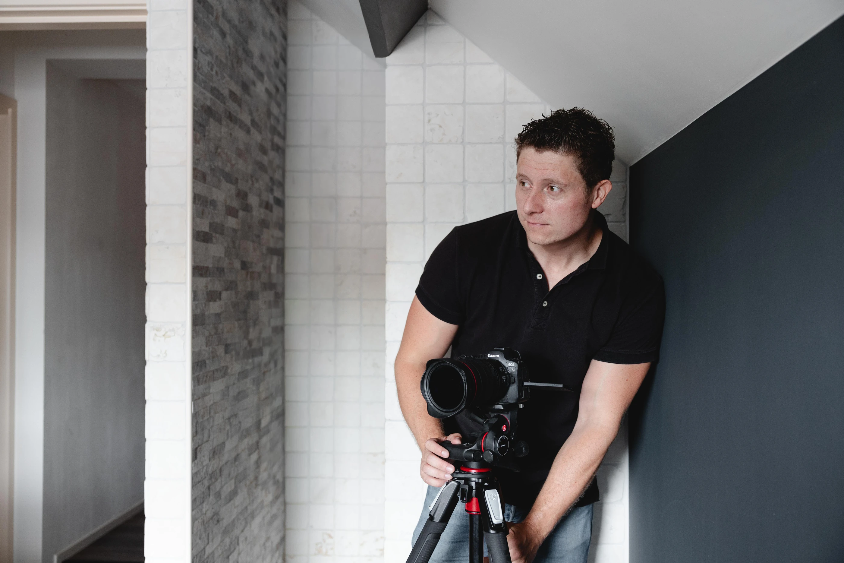 Vastgoedfotograaf van Jobse met camera op statief in de hal van een woning